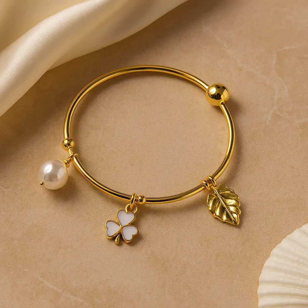 Gold plated bracelet with pearl clover and leaf charm