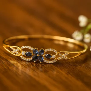 Navy blue stone floral bracelet in gold finish with intricate diamond outline for sophisticated party looks