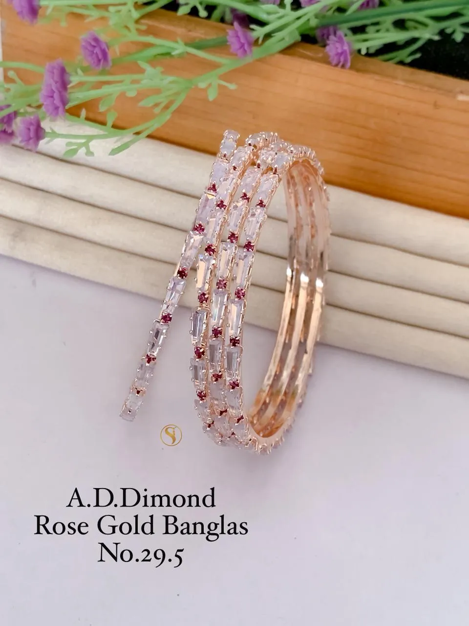 Rose gold kadli bangles with ruby stone highlights