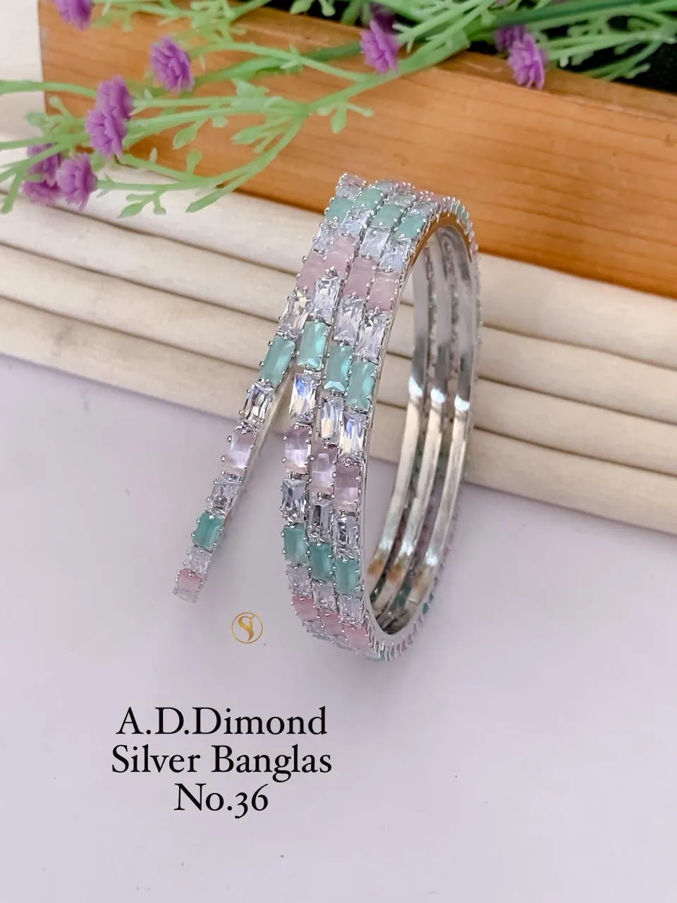 Golden bangles with ruby accent stones