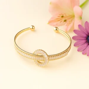 Gold open cuff with circle loop baguette design