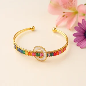 Gold cuff bracelet with multicolor baguette stones and circle centerpiece